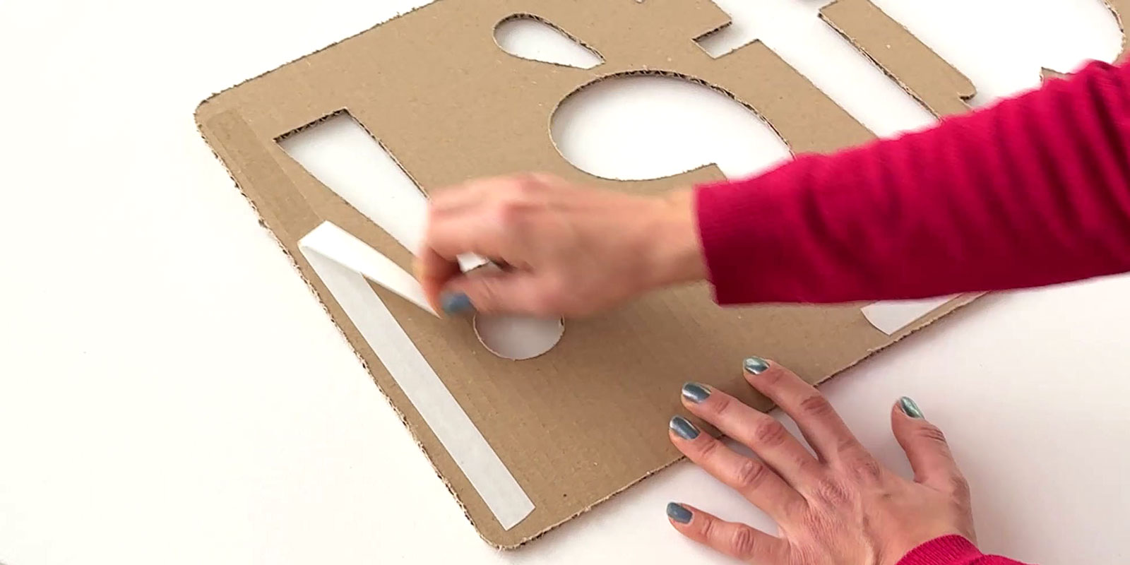 Removal of the protective film from the repositionable adhesive on the back of the installation template