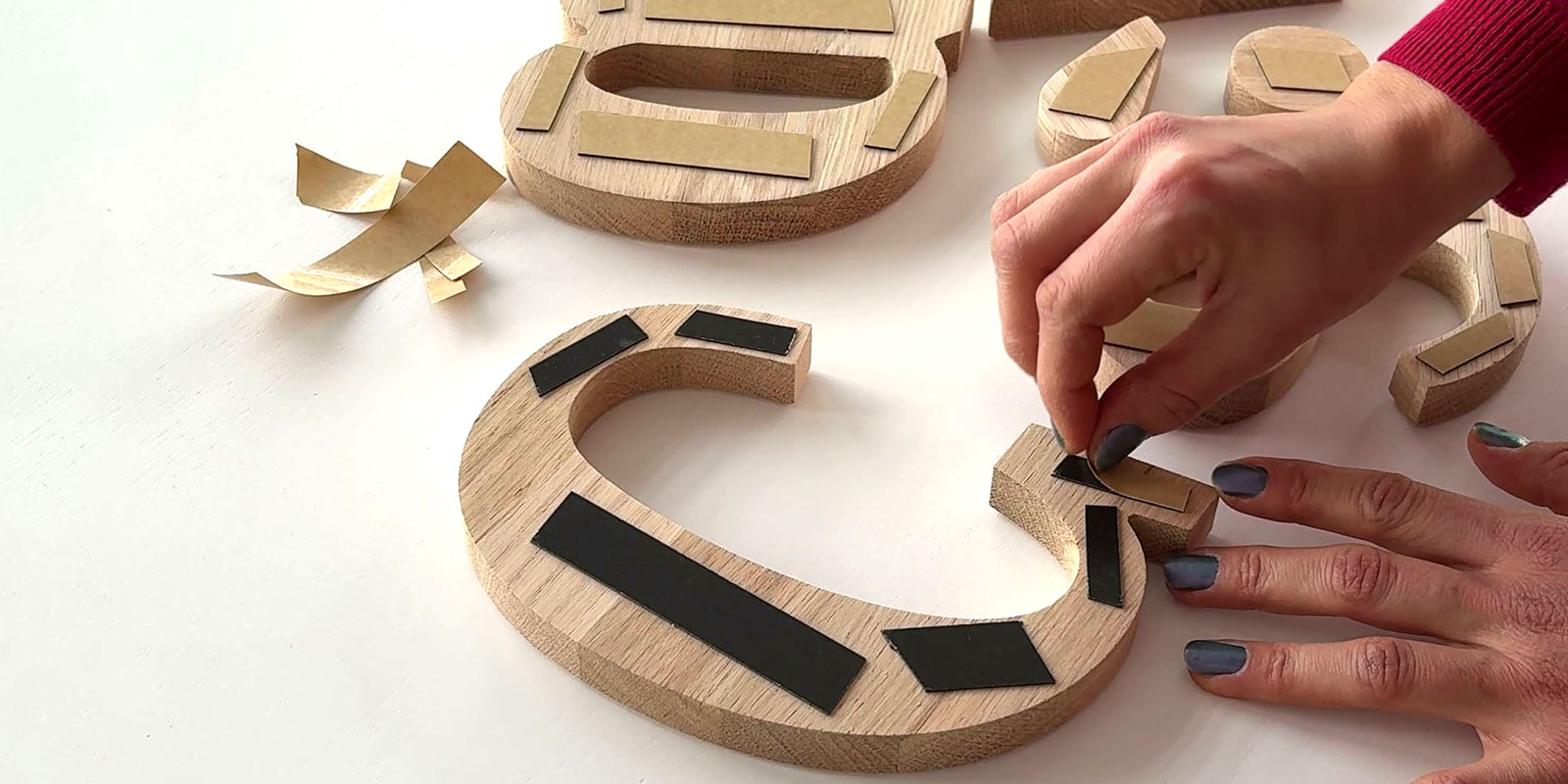 Removal of the protective films from the double-sided foam tape on the back of the letters